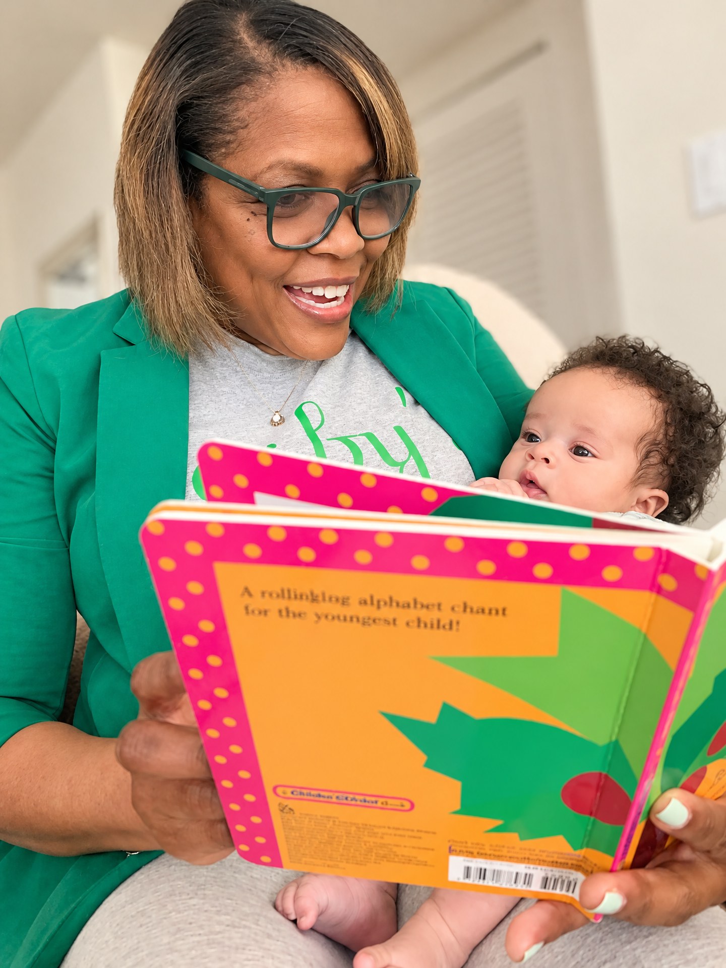 Garyon reading a picture book with a baby